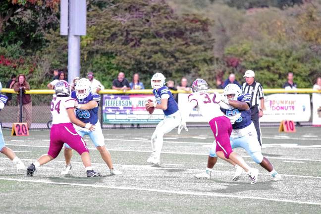 High Point remains undefeated <b>SN2 Sparta quarterback Shane Hoover holds the ball as he scans the field for an open receiver. He threw for 253 yards.</b>