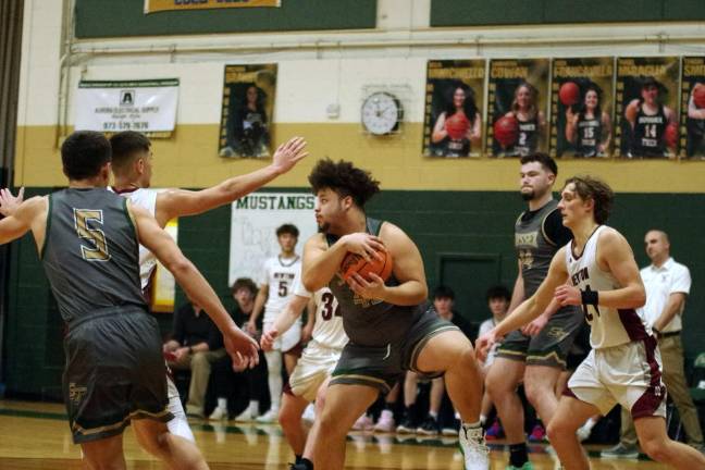 Jeremiah Fontanez holds the ball after a rebound. He grabbed three rebounds and scored one point.