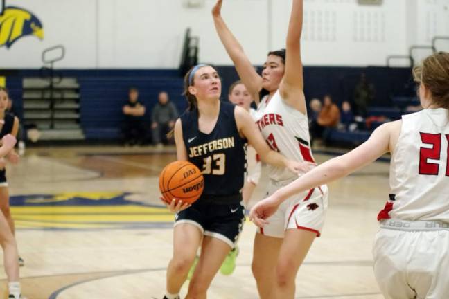 Jefferson senior Emily Poulas (33) scored 10 points and made the 195th three-pointer of her career, setting a school record.