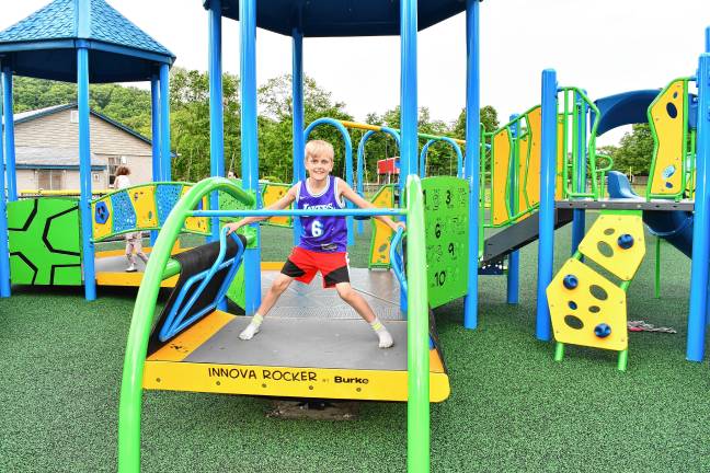 Inclusive playground opens CIP2 Patrick Rixon tries out the new equipment. (Photo by Maria Kovic)