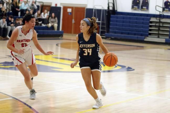 Jefferson's Riley Strauch dribbles the ball while covered by Glen Rock's Mia Vergel de Dios.