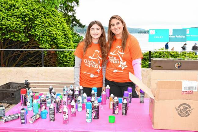 Photos: Girls on the Run 5K Kelly Lucadamo and Cassidy Hagner of Sparta at a table full of face paint.