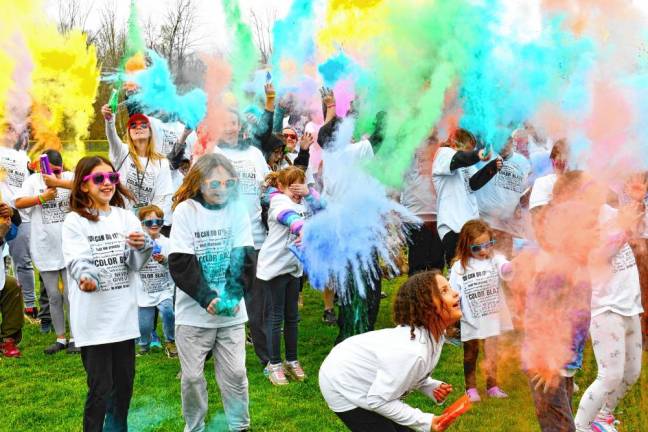 Color packets explode before the Color Run. (Photos by Maria Kovic)