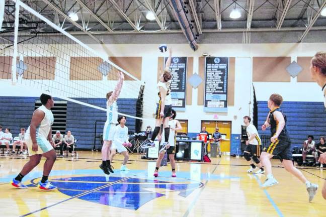 Jefferson's Raymond Bradley reaches for the ball high above the net in the volleyball match against Sparta there Thursday, April 11. The Falcons won, 25-18, 25-19. Bradley was credited with two kills and two digs. (Photos by George Leroy Hunter)