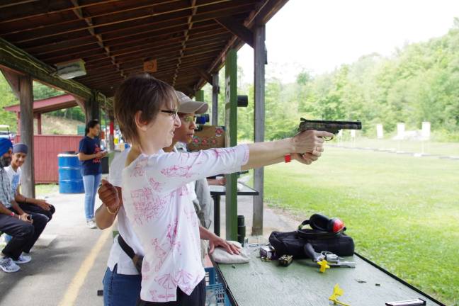 Cherry Ridge Range holds family day For Anita Collins of Hamburg it was her first time shooting firearms. Here she is shown with handgun instructor Genesis Liu.