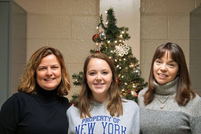 From left, Choral and Theater Director Theresa Riccardi, Hannah Orr, and Assistant Choral Director Dori Martin stand in the High Point Music Department.