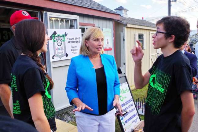 At right Newton High School robotics team Public Relations Leader Liam Oakes speaks with Lieutenant Governor of New Jersey, Kim Guadagno. Lieutenant Governor of New Jersey, Kim Guadagno met with the Newton High School robotics team at the Sussex County Fair on Monday, August 8th 2016. Ms Guadagno interacted with the team members as they spoke with her about science and engineering and demonstrated several machines built by the team.