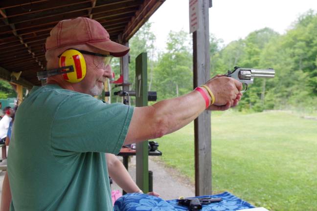 Tom McClachrie of Vernon tries out a .38 caliber revolver at the handgun range at Cherry Ridge Range. He brought his daughter Elizabeth to the range to learn more about the safe handling of firearms.