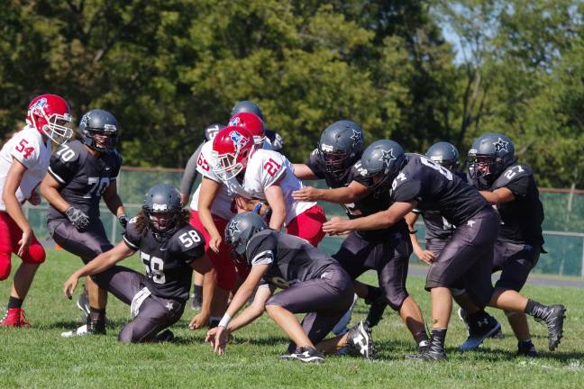 A Lenape Valley ball carrier moves the ball through a pack of Wallkill Valley defenders.