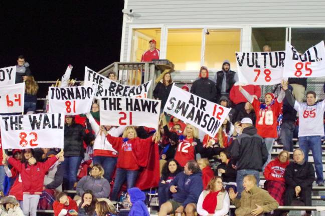Wearing the team colors Lenape Valley Patriots fans held up signs supporting their favorite senior players.