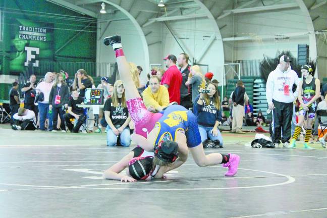 Female athlete competes in national wrestling competition Marlee taking down her opponent during the nationals.