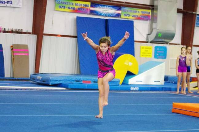 Westys gymnast Samie Copley begins a drill. Copley, 11, earned two regional championship titles earlier this year.