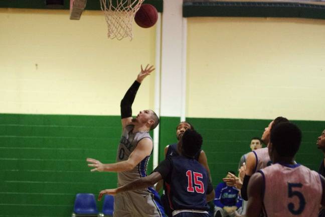 SCCC falls in basketball showdown Sussex County Skylander Patrick McNamara (0) shoots from beneath the basket. McNamara, of Hopatcong, scored a team high of 13 points.