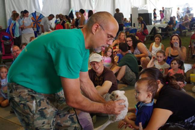 Dominic Rizzo of Rizzo's Reptiles moves through the crowd with a chinchilla that the keeps were able to touch.