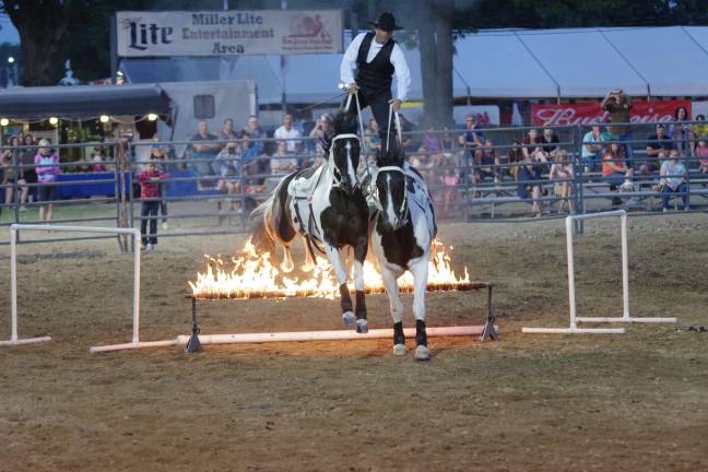 Bucking broncos at the NJ State Fair Tommie Turvey the Equestrian Entertainer and his horses hurtle fire.