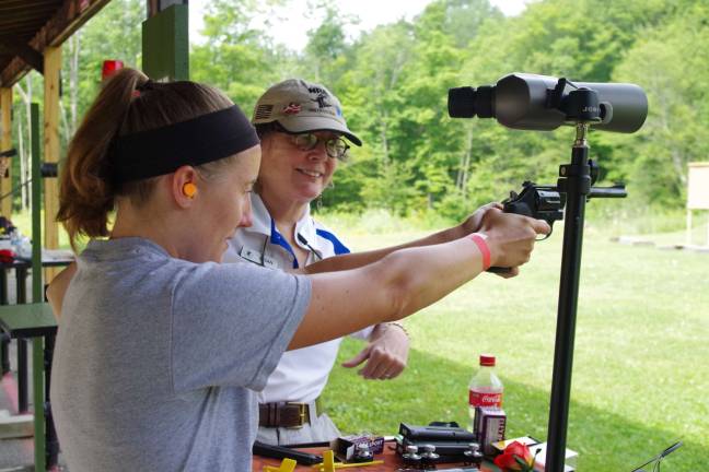 Elizabeth McClachrie, 23, of Vernon samples a .38 caliber revolver at Cherry Ridge Range on Sunday. Her instructor was Susan Jones.