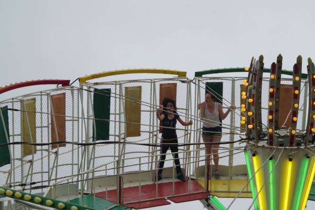 A girl takes a &#x201c;selfie&#x201d; while on the tilt-a-whirl.