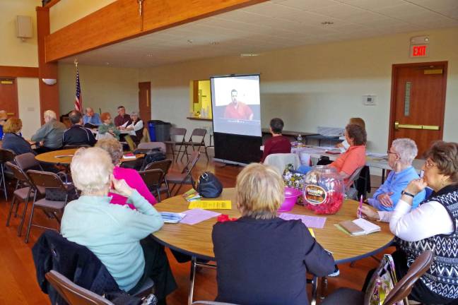 PHoto by Chris Wyman Seniors watch a video of a convicted burglar explaining what he used to look for before he broke into a house.