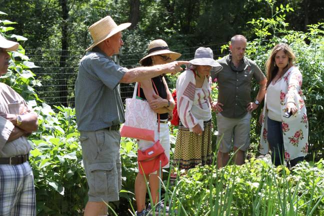 Frank Hennion showing ticketholders around his garden.