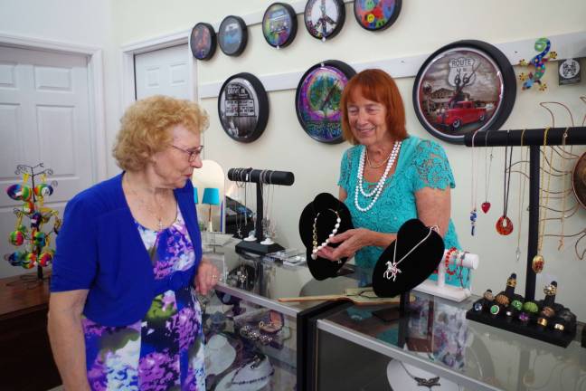 At left, Sussex Borough Mayor Katherine Little is shown some unique jewelry by co-owner Lynne Beccari.