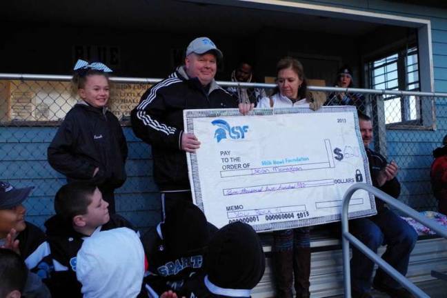 Brian Monaghan and his family pose with the donated $6200 check.