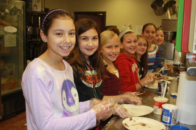 Helen Morgan fifth graders bake cookies at Family Volunteer Day. Pictured left to right Jollie Dottinger, Athena Battaglia, Paige Mongon, Tristen Pallito, Nicole Strouse, Katie Groome and Emma Muth.