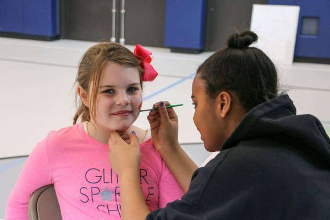 PHOTOS BY LAURA MARCHESE Faith Kansky, left, is shown getting her face painted by Hannah Ripley.