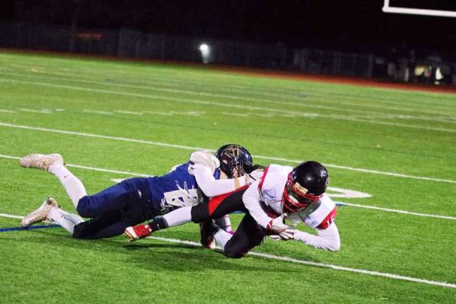 A Sussex defender brings down a Watertown ball carrier.