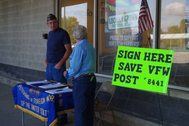 Photo by Chris Wyman Jean Mize, the Chaplin of the VFW Women&#x2019;s Auxiliary speaks to Bob Constantine Past Commander and Chairman.