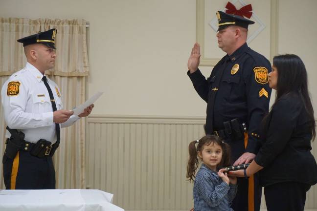 Ogdensburg swears in new officers Ogdensburg police chief Stephen Gordon swears in Sgt. Stephen Davis, right, while his wife, Gina, holds the Bible.