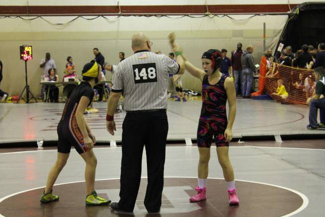 Female athlete competes in national wrestling competition Smith at nationals.