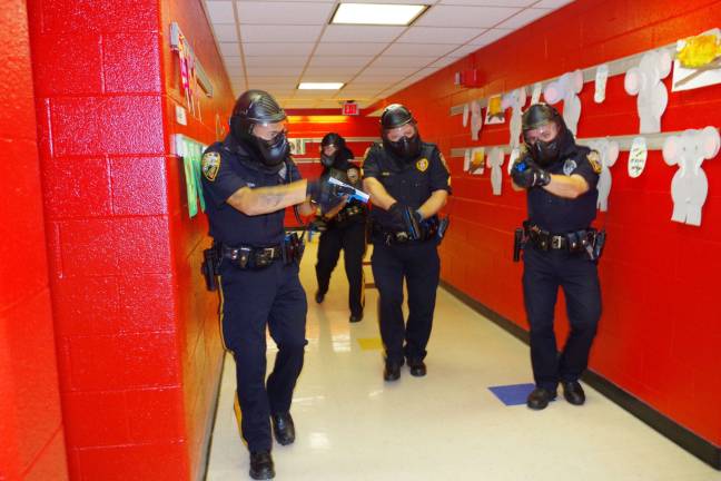 Photo by Chris Wyman During an active shooter drill, four Vernon police officers go through Walnut Ridge Elementary School looking for three shooters. The drill took place in august.
