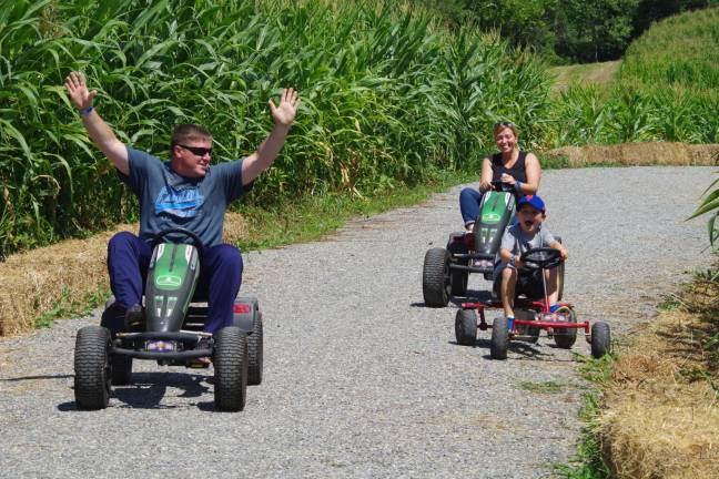 Visiting Vernon from East Rutherford, Frank Peters starts his victory lap after speeding past his wife Michelle and son Colin, 6, at Heaven Hill Farm&#x2019;s Pedal Cart Racecourse.