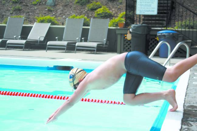 Volunteer group hosts swim-a-thon Michael O'Krepky dives in to the pool.