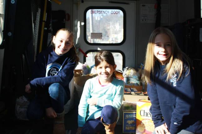 Helping 'stuff the bus' last Saturday for the Sussex County Food Pantry: Julia Lengen, Peighton Spidaletto and Maddie Powell.