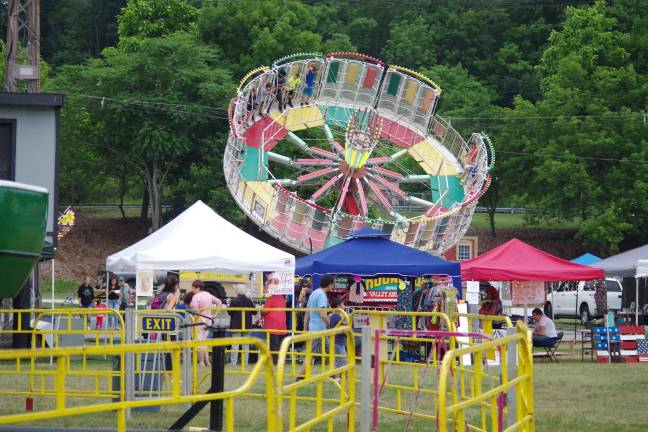 The tilt-a-whirl is shown high in the air during the Franklin annual carnival.