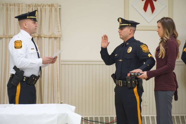 Ogdensburg swears in new officers Ogdensburg police chief Stephen Gordon swears in Sergent Joseph Sanfilippo, right, with Victoria Matyola holding the Bible.