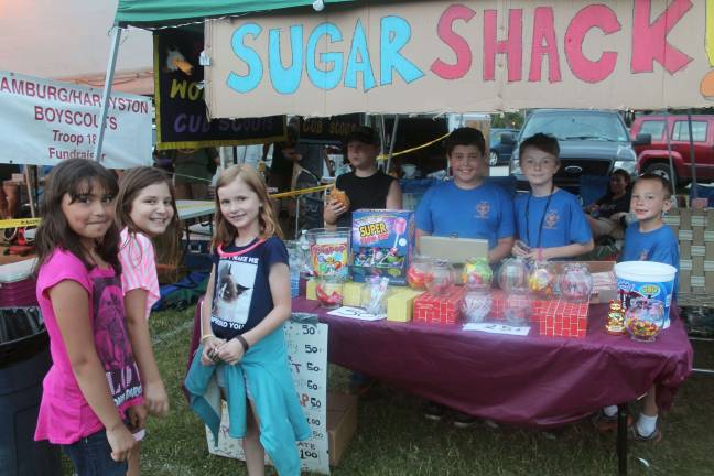 Members of Franklins Pack 90 Cub Scouts help some customers select candy at their Sugar Shack at this years Franklin Day. This year the scouts sold candy, Root Beer floats and iced coffee to raise money for their pack.
