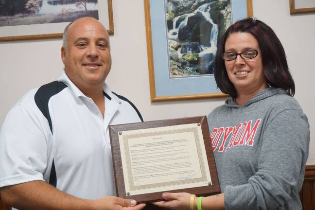 Patricia DaSilva received the Childhood Cancer Awareness plaque recognizing September as Childhood Cancer Awareness Month in Ogdensburg.