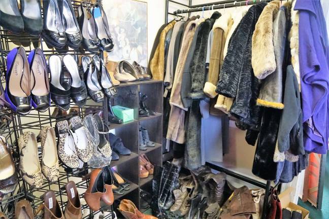 Shoes and winter coats are displayed for sale.