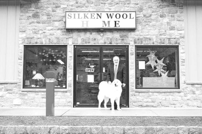 Photos by Chris Wyman Silken Wool Home owner Bruce Ghorbanian and his dog &#xec;Quincy,&#xee; a four-year-old, nearly 100 pound Polish Tatra are shown in front of the Route 94 showroom. The friendly canine greets visitors as they enter the showroom.