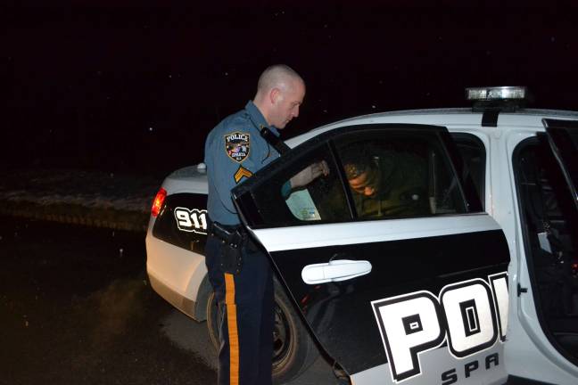 Sparta police nab alleged thieves Cpl. Marc Rubino secures gang member Courry Rice in the rear of his patrol vehicle. RiceþÄôs bail was set at $200,000.00 without a 10 percent option. (Photo Courtesy of the Sparta Township Police Department).