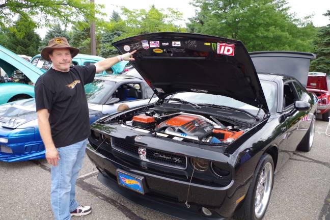Classic car show to benefit Parkinson's research Bllair Debois of West Milford, New Jersey points to some of the celebrity autographs on his customized 2010 Dodge Challenger R/T.