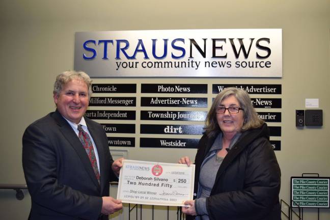 Frank Curcio, the director of sales and marketing for Straus Newspapers Inc., presents a check for $250 to Debra Silvano the most recent winner of the Straus News Shop Local Sweepstakes. She entered the contest by submitting her receipt from Adams Fairacre Farms in Newburgh, NY.