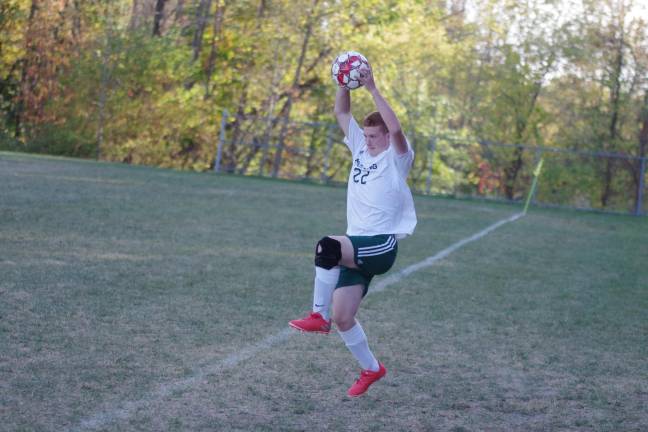 A Sussex Tech Mustang throws the ball into play.