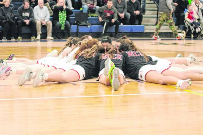 The Glen Rock Panthers in a huddle before the start of the game.