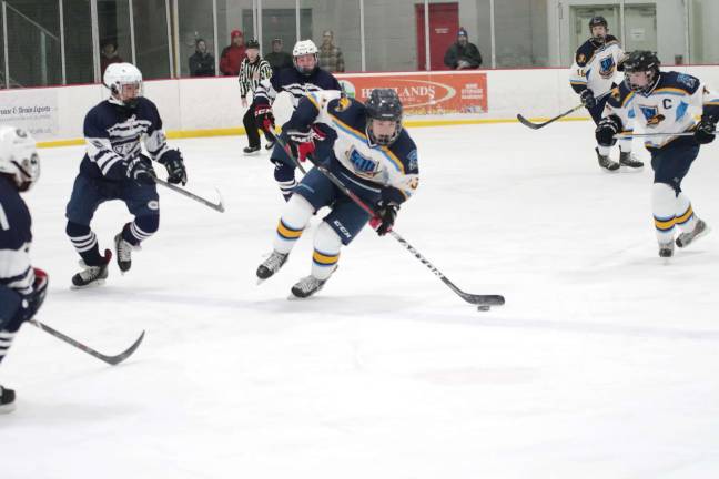 Sparta-Jefferson United hockey player James Battaglia steers the puck in the first period.