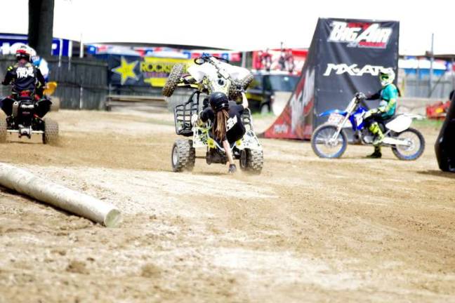 Photos by George Leroy Hunter Stuntman J.R. Hinds performs a wheelie while riding an all terrain vehicle.
