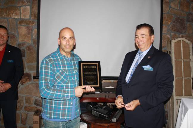 Steve Scro, owner of Mohawk House, receives an award from Pat Aramini for his support of The 200 Club of Sussex County.