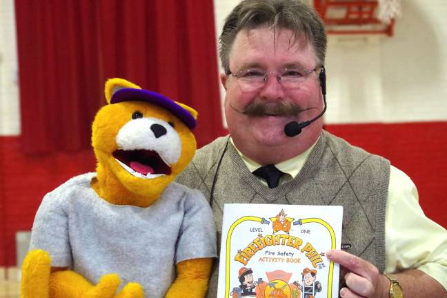 Firefighter Phil visits Hamburg school Firefighter Phil, portrayed by ventriloquist Dave Carr with the help of þÄúAl E. CatþÄù holds one of three activity books that were given to the students at the Hamburg School.